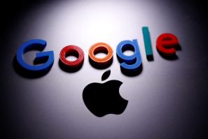 A 3D printed Google logo is placed on the Apple Macbook in this illustration