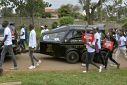 Anti-femicide marchers walk alongside a hearse carrying the body of murdered Olympian Rebecca Cheptegei in western Kenya