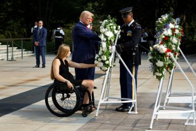 Donald Trump lays a wreath alongside retired Marine corporal Kelsee Lainhart, who was injured in a bombing during the US withdrawal from Afghanistan, in an August 26 ceremony at Arlington National Cemetery near Washington