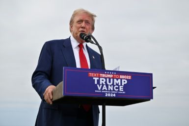 Donald Trump talks to reporters at his golf course outside Los Angeles ahead of a rally in Nevada