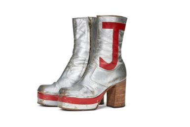 Elton John's monogrammed silver leather boots sold for nearly $100,00 at auction in New York