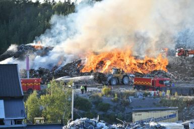 Firefighters tackle a blaze at a Think Pink landfill site at Botkyrka, south of Stockholm