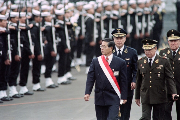 Former Peruvian president Alberto Fujimori, pictured reviewing a guard of honor while in office in 1995. He died on Wednesday at the age of 86 in Lima