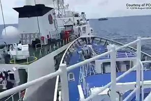 A frame grab from handout video footage taken and released on August 31 by the Philippine Coast Guard shows a Chinese coast Guard ship (left) colliding with the Teresa Magbanua