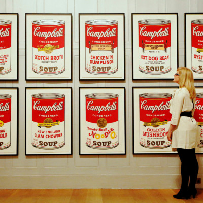 Gallery employee Maddy Adeane poses with Andy Warhol's "Campbell's Soup II" (1969) at the Dulwich Picture Gallery in London