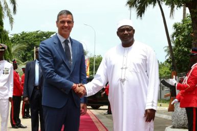 Gambian President Adama Barrow (R) welcomes Spanish Prime Minister Pedro Sanchez (L) upon his visit to Banjul on August 28