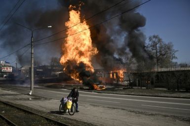 A man flees after artillery fire on Kharkiv on March 25, 2022