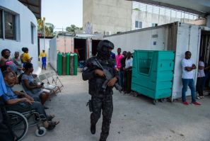 A police officer patrols during a visit of Haitian Prime Minister Garry Conille at Hospital Bernard Mevs in Port-au-Prince, Haiti on August 28, 2024