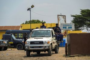 A police vehicle with officers leaves the Makala prison