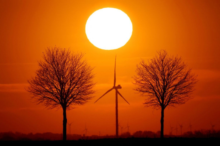 Power-generating windmill turbines are seen during sunset in Bourlon, France, February 23, 2021.