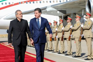 The president of Iraq's autonomous Kurdistan region, Nechirvan Barzani, welcomes Iran's President Masoud Pezeshkian at Arbil airport