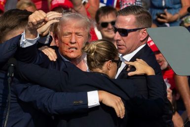 Republican presidential candidate Donald Trump is evacuated from a rally by Secret Service agents after an assassination attempt in Butler, Pennsylvania, on July 13, 2024