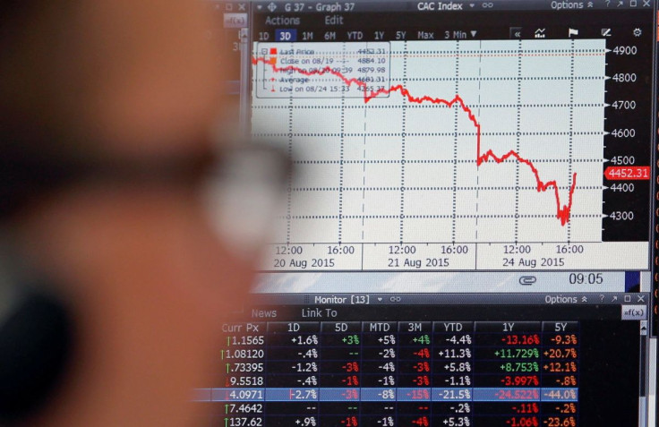 A sales manager looks at a screen which shows the decline in value of French CAC 40 stocks at Allianz Global Investors in Paris, France, August 24, 2015.