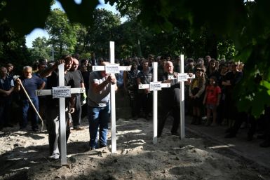 Some mourners knelt in the street as the funeral procession passed