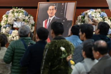 Supporters of the late former Peruvian President Alberto Fujimori (1990-2000) wait to enter the Culture Ministry where he lay in state in Lima on September 13, 2024 ahead of his funeral on September 14, 2024. Peru's former president Alberto Fujimori, who 