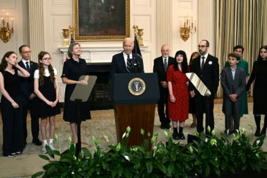 US President Joe Biden, standing alongside family members of the freed prisoners, speaks about the prisoner exchange with Russia, in the State Dining Room of the White House in Washington, DC, on August 1, 2024. Biden hailed the prisoner swap with Russia 