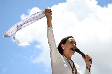 Venezuelan opposition leader Maria Corina Machado speaks to supporters while holding up electoral records during a rally in Caracas on August 28, 2024