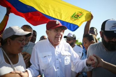 Venezuelan opposition presidential candidate Edmundo Gonzalez Urrutia (C), greets supporters on the campaign trail